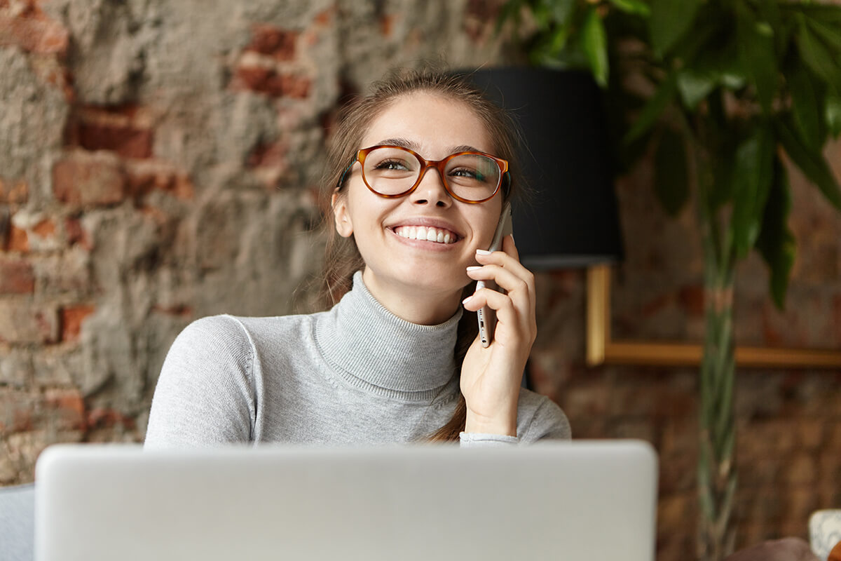 happy-student-girl-enjoying-modern-gadgets-talkin-38V62MX.jpg